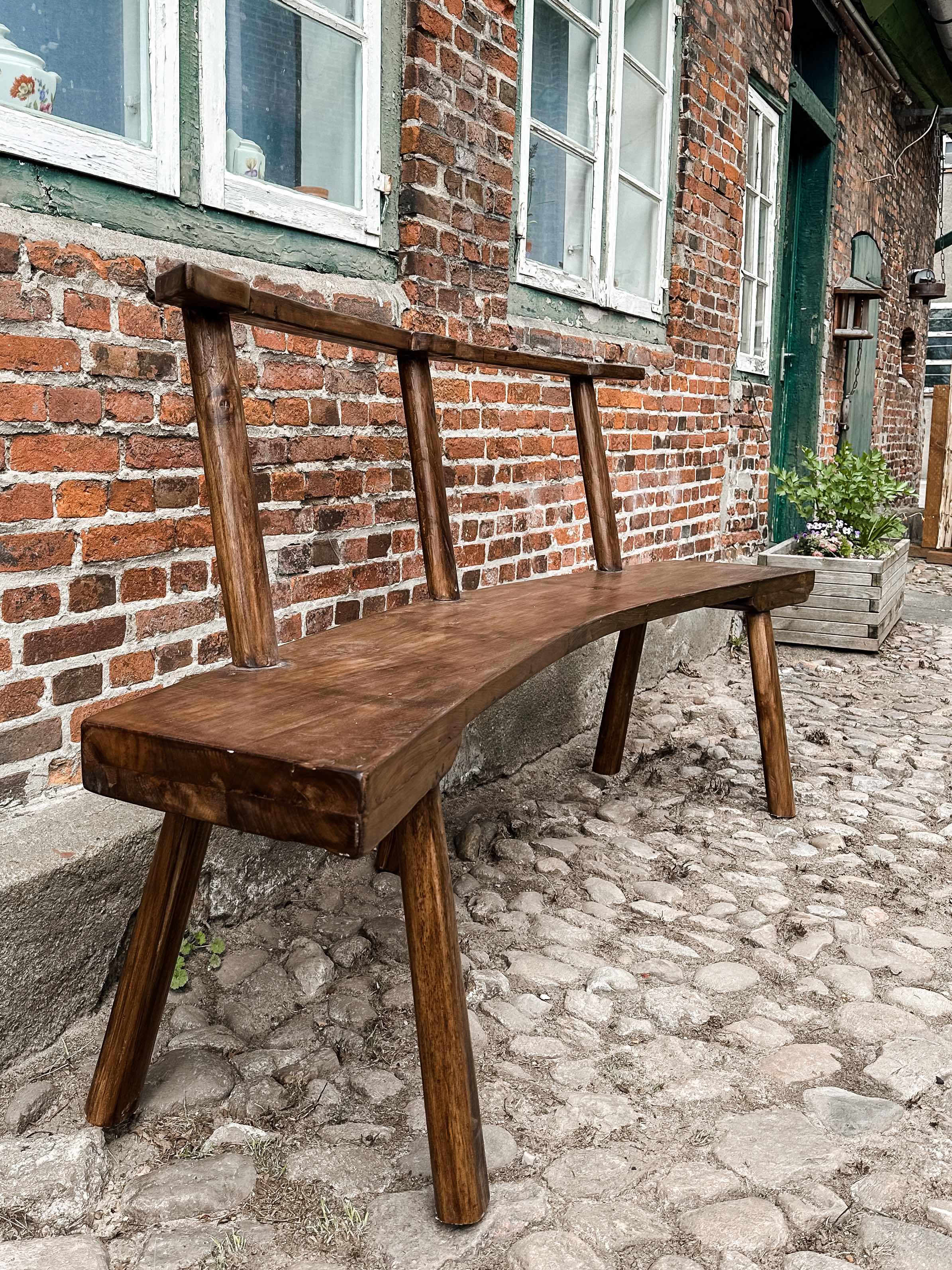 The curved teak bench