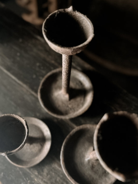 old cast iron candle holder