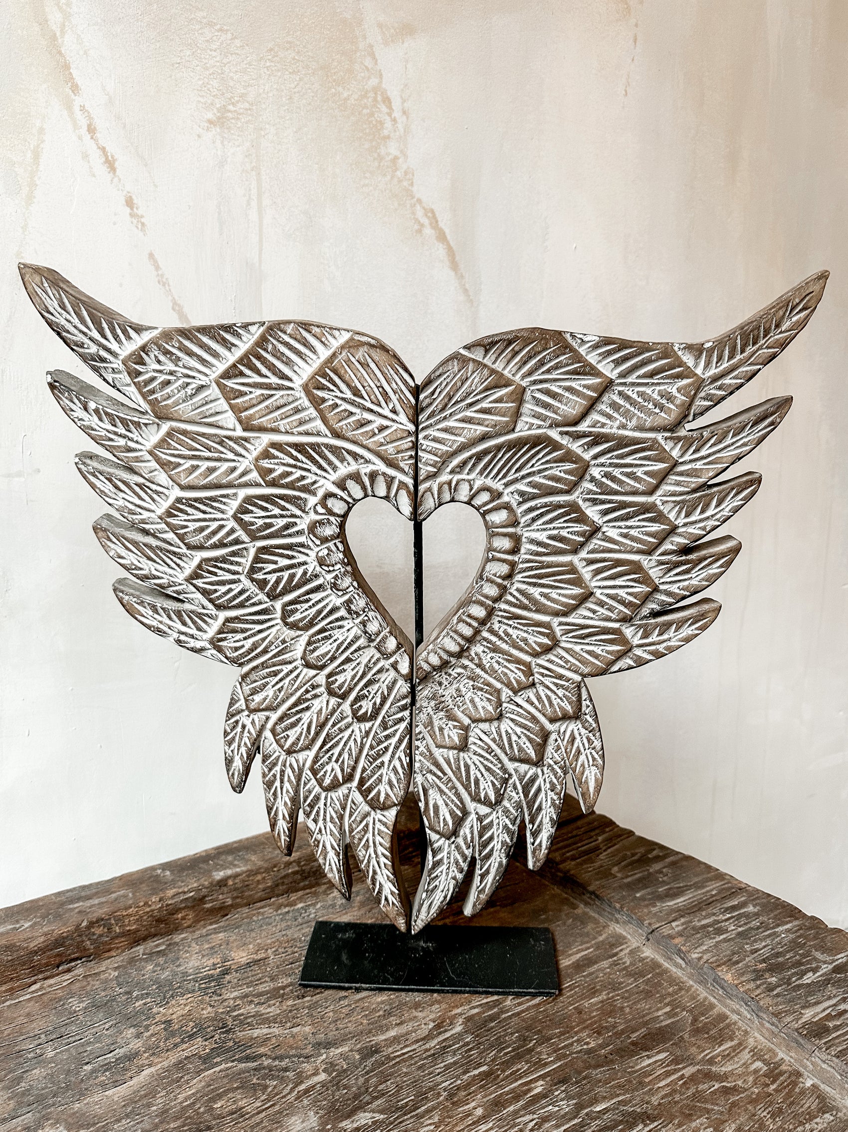 hand carved angel wings on metal stand